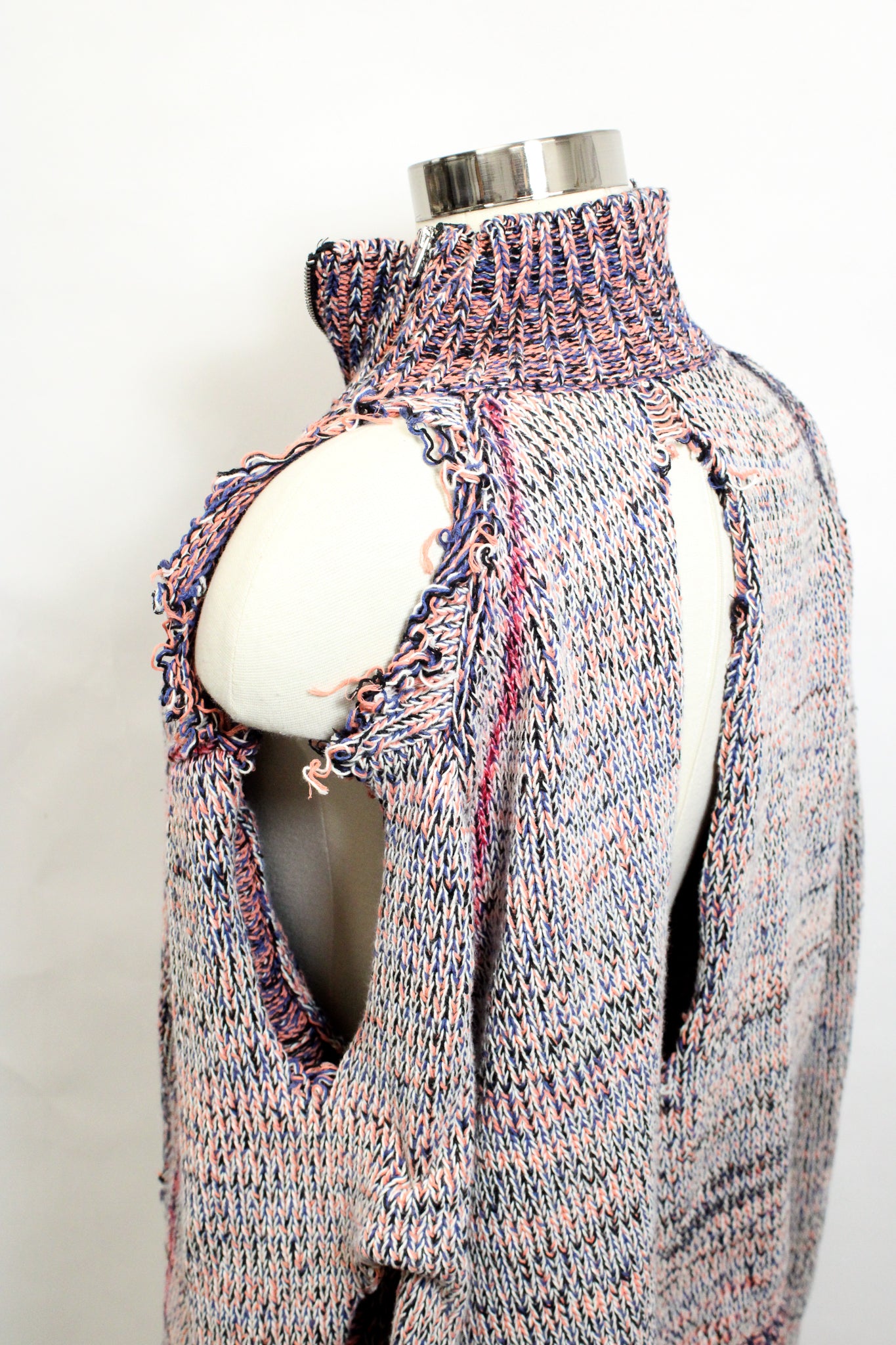 side view of sweater showing holes in the shoulder and back