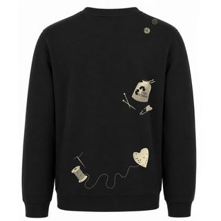 Backside of a black fleece crewneck sweatshirt featuring champagne screenprinted motifs and embroidery that celebrate FABSCRAP's mission and decade of work