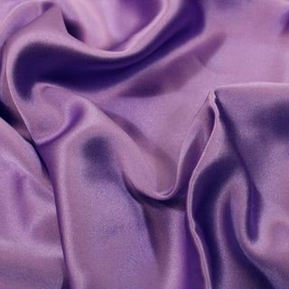 close-up of rumpled, light purple, silk charmeuse fabric, detailing the satinweave