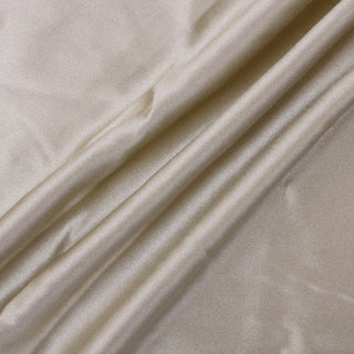 three draping lines of champagne colored silk charmeuse fabric, demonstrating the lightweight draping hand and high-shine face