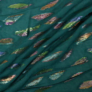 three diagonal lines arranged of a lightweight emerald fabric with an organically shaped rainbow lurex pattern woven throughout