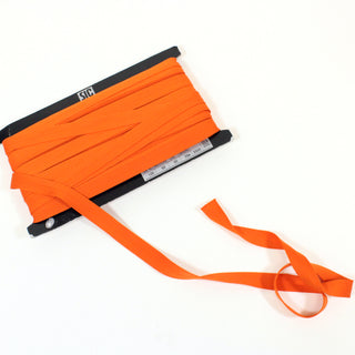 black card with orange knit tape wrapped around it