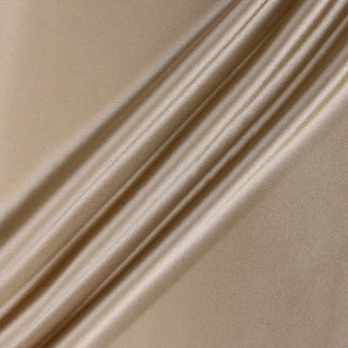 three diagonal lines draped across a caramel colored crepe-back satin fabric to show its lustrous shine and soft draping quality