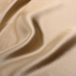 close-up of caramel crepe-back satin fabric