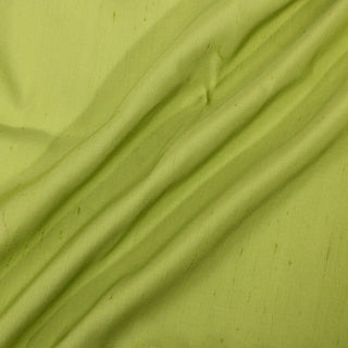 three draped lines of chartreuse colored shantung silk fabric, demonstrating its slub ribweave and crisp drape