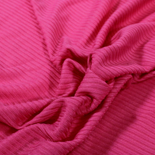close-up of a hot pink rib knit jersey fabric, detailing the 4x4 rib structure