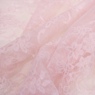 close-up of a baby pink colored stretch mesh lace trellis-floral fabric, detailing the fabric structure and motif