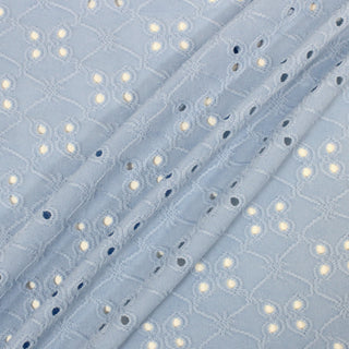three diagonal lines draped of a baby blue colored eyelet jersey fabric with a trellis pattern texture throughout