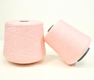 two large cones of ballerina pink yarn, ultra-fine weight and luxurious hand