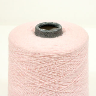 close-up of a spool of luxurious ballerina pink colored ultra-fine-gauge yarn