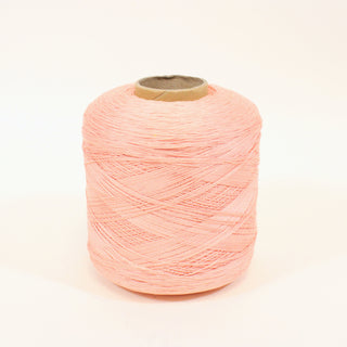 large cone of ballerina pink colored fine-gauge worsted yarn
