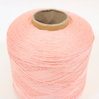 close-up of a large cone of fine-gauge worsted ballerina pink colored yarn