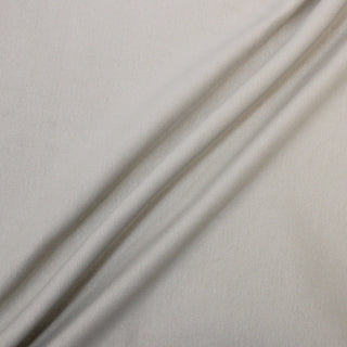 three diagonal lines draped of a beige 1x1 rib tube-knit jersey fabric