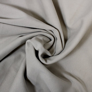 swirl of beige 1x1 rib knit jersey fabric, demonstrating its tightly knit structure and heavier weight