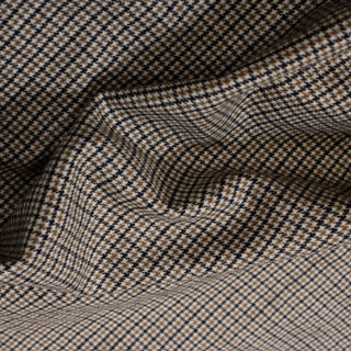 close-up of a beige and black checked lightweight suiting fabric, detailing the check pattern and drapey hand