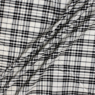three diagonal lines draped of a black and white plaid silk taffeta