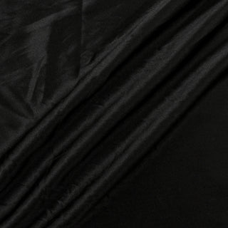 three diagonal lines draped of a black silk charmeuse fabric