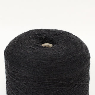 close-up of a cone of black fine-gauge yarn with slubs