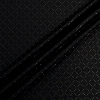 ripple of black interlock fabric that has black diamond pattern printed on it