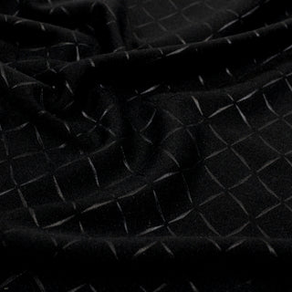 close-up of black interlock fabric that has black diamonds printed on it