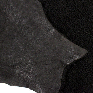 close-up of double sided black sheepskin, one side sherpa and the other leather