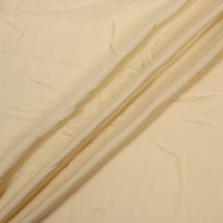 blonde colored silk chiffon fabric with three lines draped diagonally across it, demonstrating the soft draping quality and lightweight hand