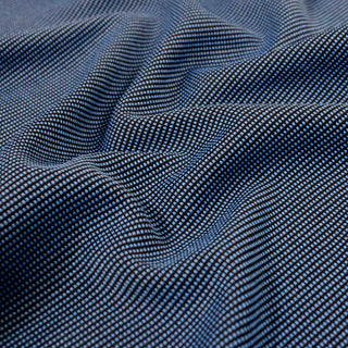 close-up of double-knit jersey fabric with black and blue stitches