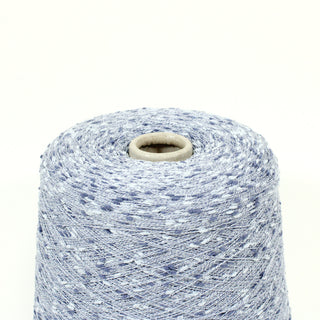 close-up of a cone of very fine-weight slub yarn in shades of blue