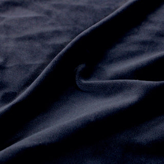 Close-up of dark blue velour fabric with a soft pile