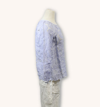 side view of blue and white stripe embroidered cutout blouse