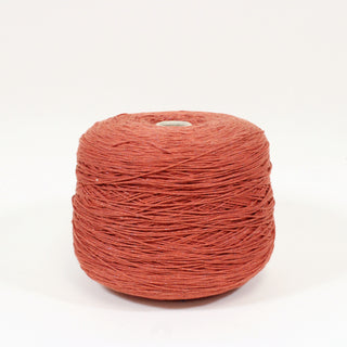 large cone of midweight brick red colored sparkle core-yarn