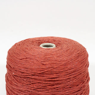 close-up of a large cone of brick red sparkle core yarn