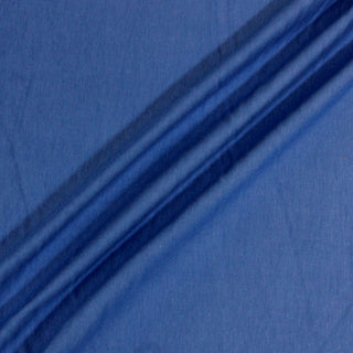 three diagonal draped lines of a bright blue knit jersey fabric