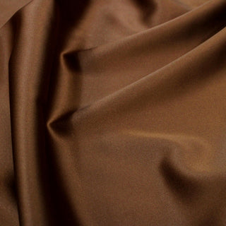 close-up of bronze stretch-silk charmeuse fabric, detailing its subtle surface shine
