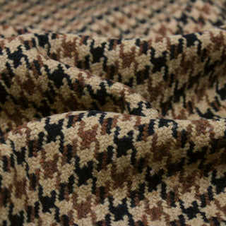 very close up photo showing details of weave of fabric: brown and black houndstooth wool
