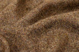 close-up photo showing weave structure of a wool, brown micro-tweed fabric