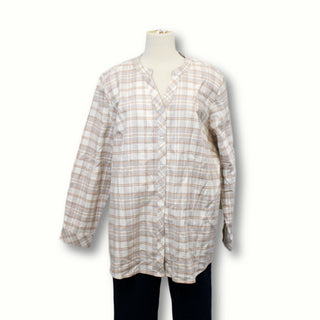 front of a brushed flannel plaid button up shirt in light neutral colors, on a mannequin in front of a white background, mannequin is also wearing dark wash jeans