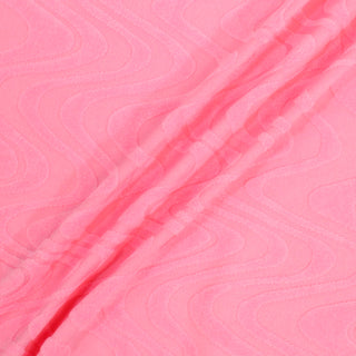 three diagonal lines draped across a bubble gum pink colored knit fabric that has a rippled velour pattern throughout
