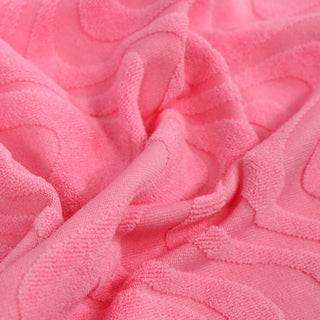 close-up of a bubble gum pink knit patterned-velour fabric