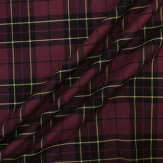 three diagonal lines draped of a burgundy wool plaid suiting fabric, demonstrating the drapeability