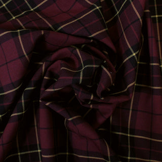 swirl of a burgundy wool plaid suiting fabric