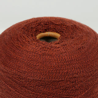 close-up of a cone of burnt sienna lace-weight yarn