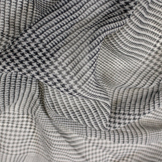 close-up of a black and white printed silk chiffon fabric, detailing the surface shine
