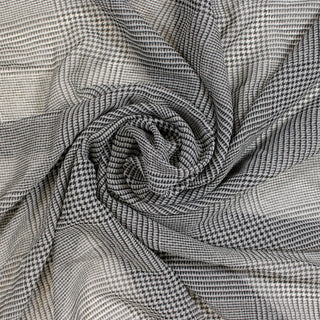 swirl of a black and white printed silk chiffon, demonstrating the drape and shine of the fabric