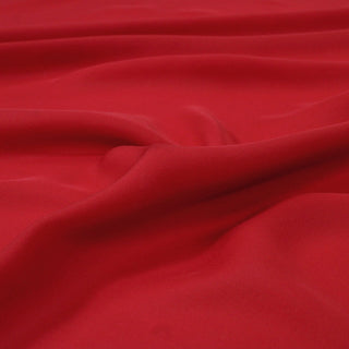 close-up photo of candy apple red silk chiffon fabric, demonstrating the soft draping qualities