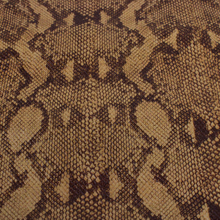 face of a caramel and dark brown colored cowhide leather piece that is embossed and printed with a snakeskin pattern
