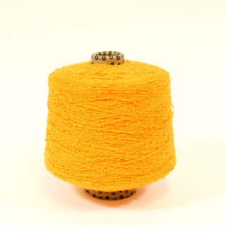 cone of carrot colored boucle yarn