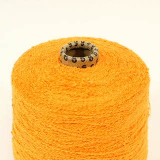 close-up of a cone of orange boucle yarn