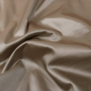 close-up of champagne colored silk taffeta fabric, detailing its textural weave and subtle surface sheen