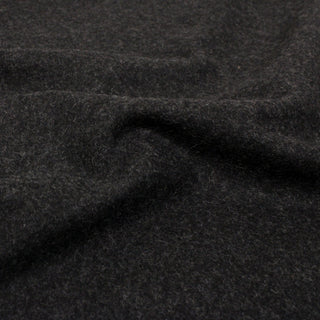 close-up of charcoal colored wool felted fabric, demonstrating the heavy hand and soft texture